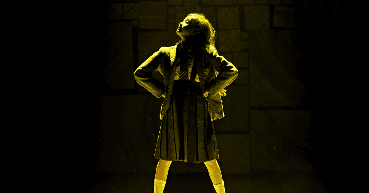 Young woman visitor using phone in the historical museum Matilda The Musical Logo